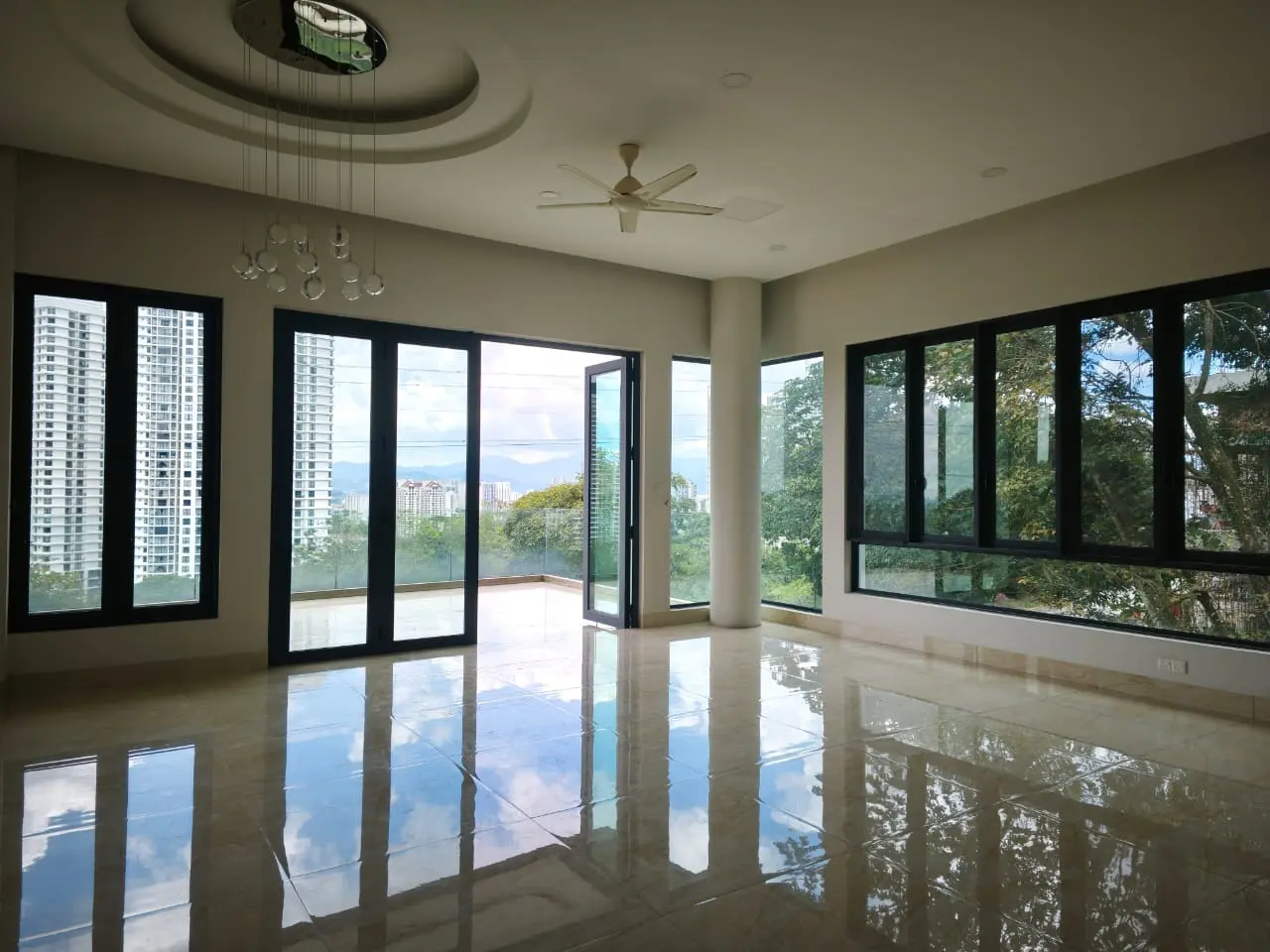 Spacious living hall with wide windows and hillside views