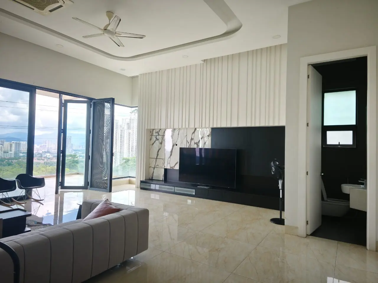 Furnished living room with feature wall and balcony access