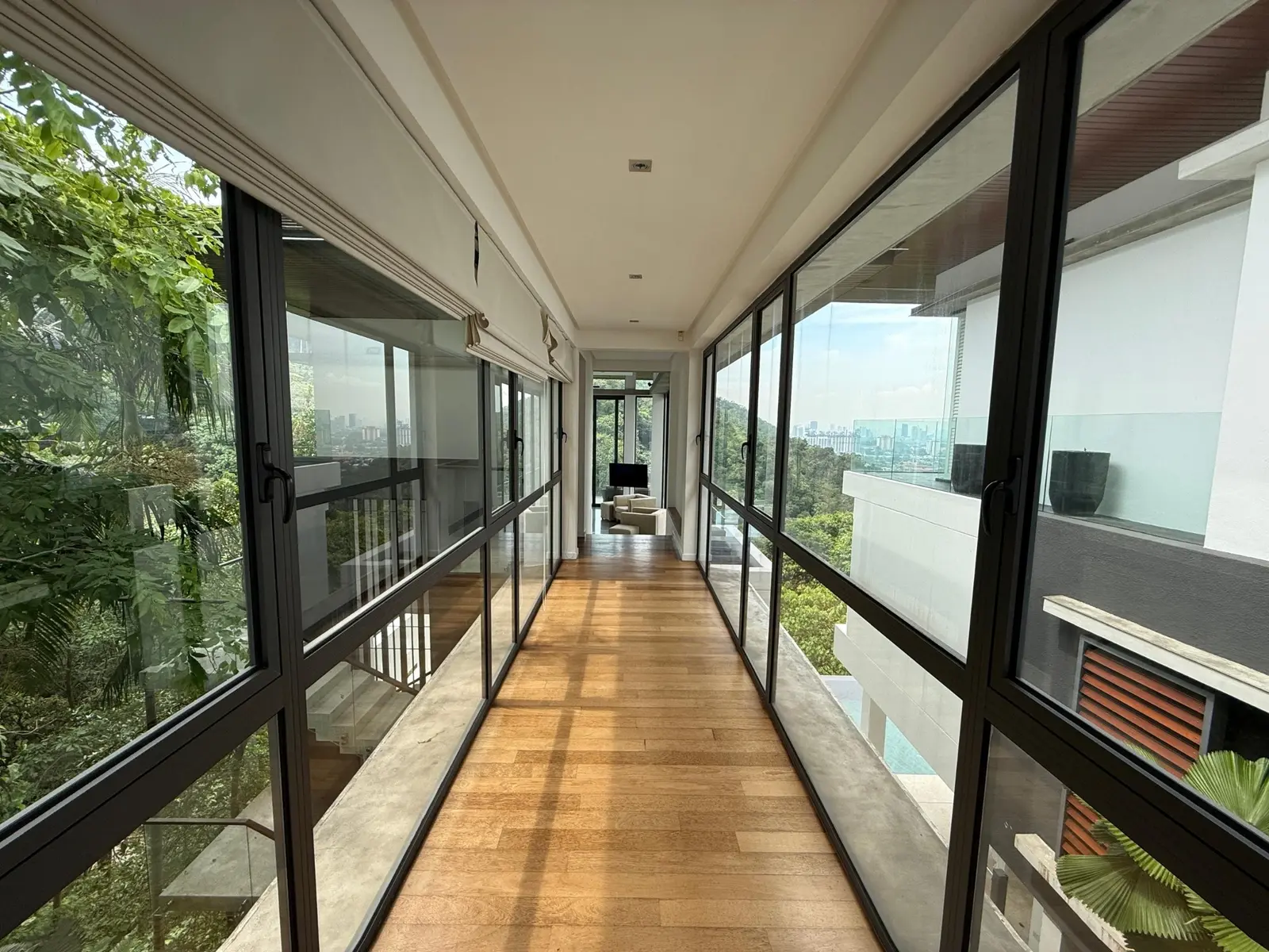 Glass-enclosed corridor connecting the bungalow's living spaces