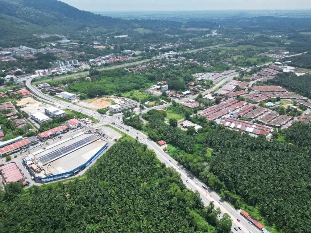 Aerial context showing roads, housing and nearby development