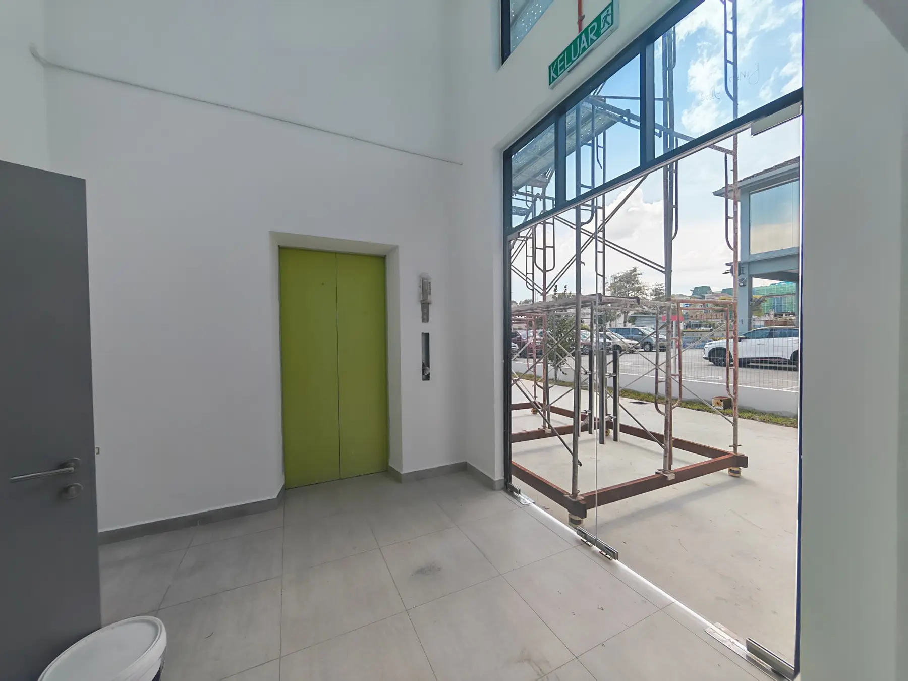 Entrance and service area beside the glazed frontage